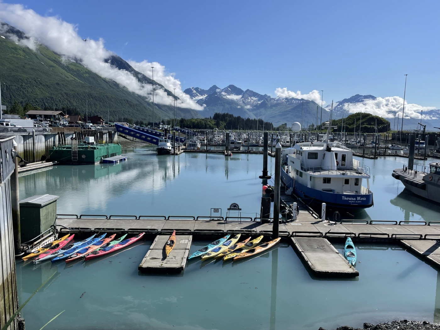 Harbor of Seward, Alaska, with kayaks and snowy peaks